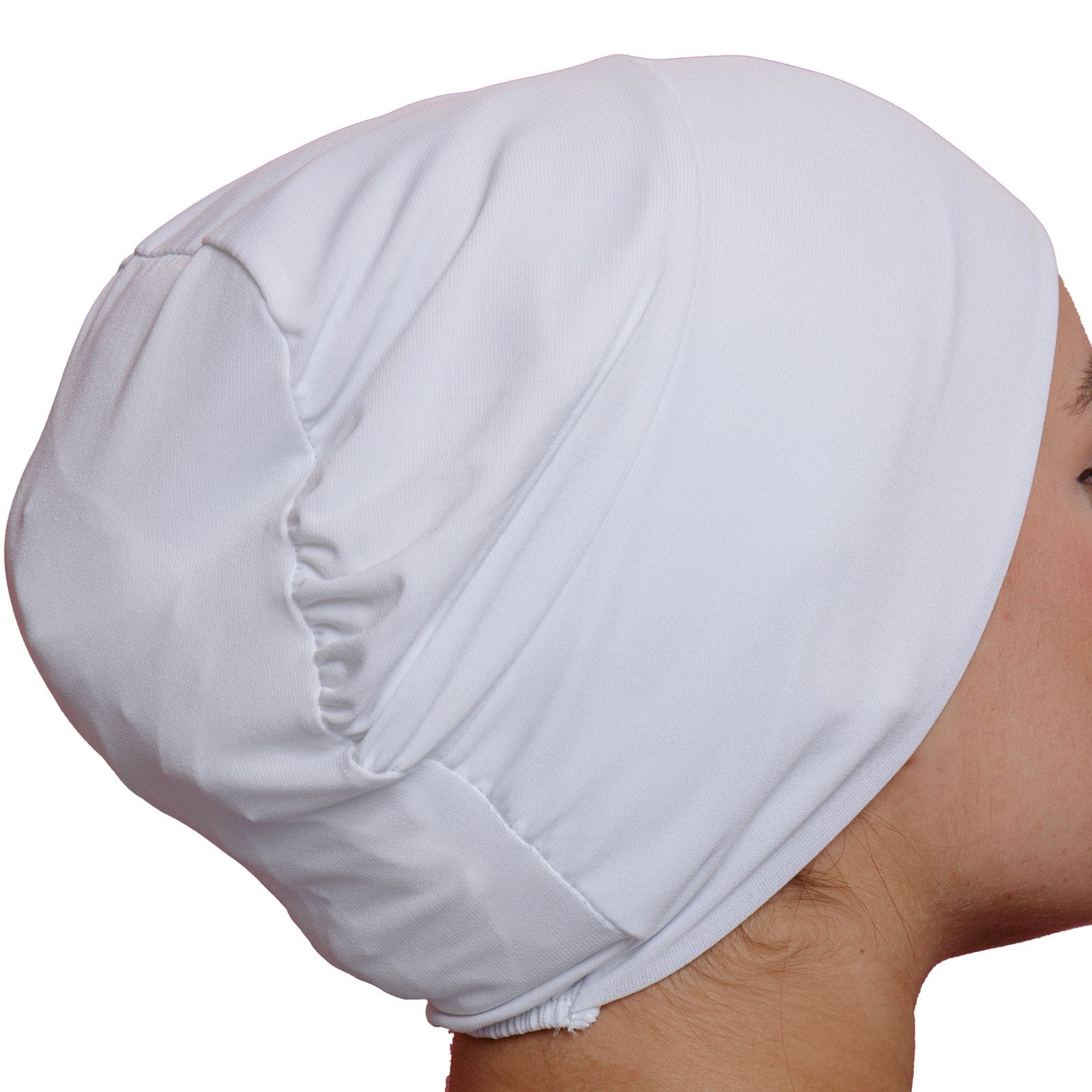 Back view of a woman in a white lycra underscarf with a gathered design. Adds volume and ensures a snug, comfortable fit.