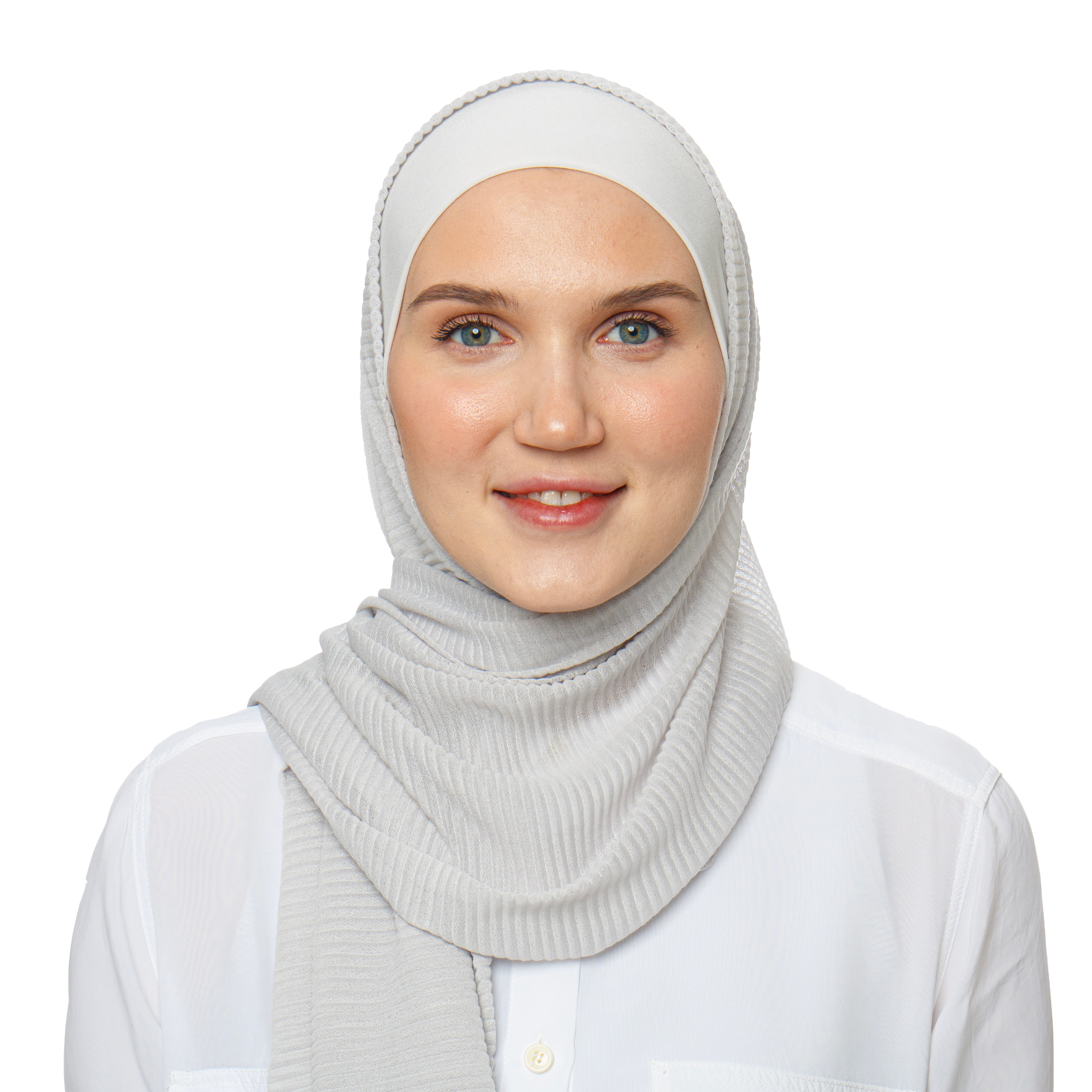 Smiling woman in a silver hijab paired with a white shirt. A timeless look for modest fashion and everyday elegance