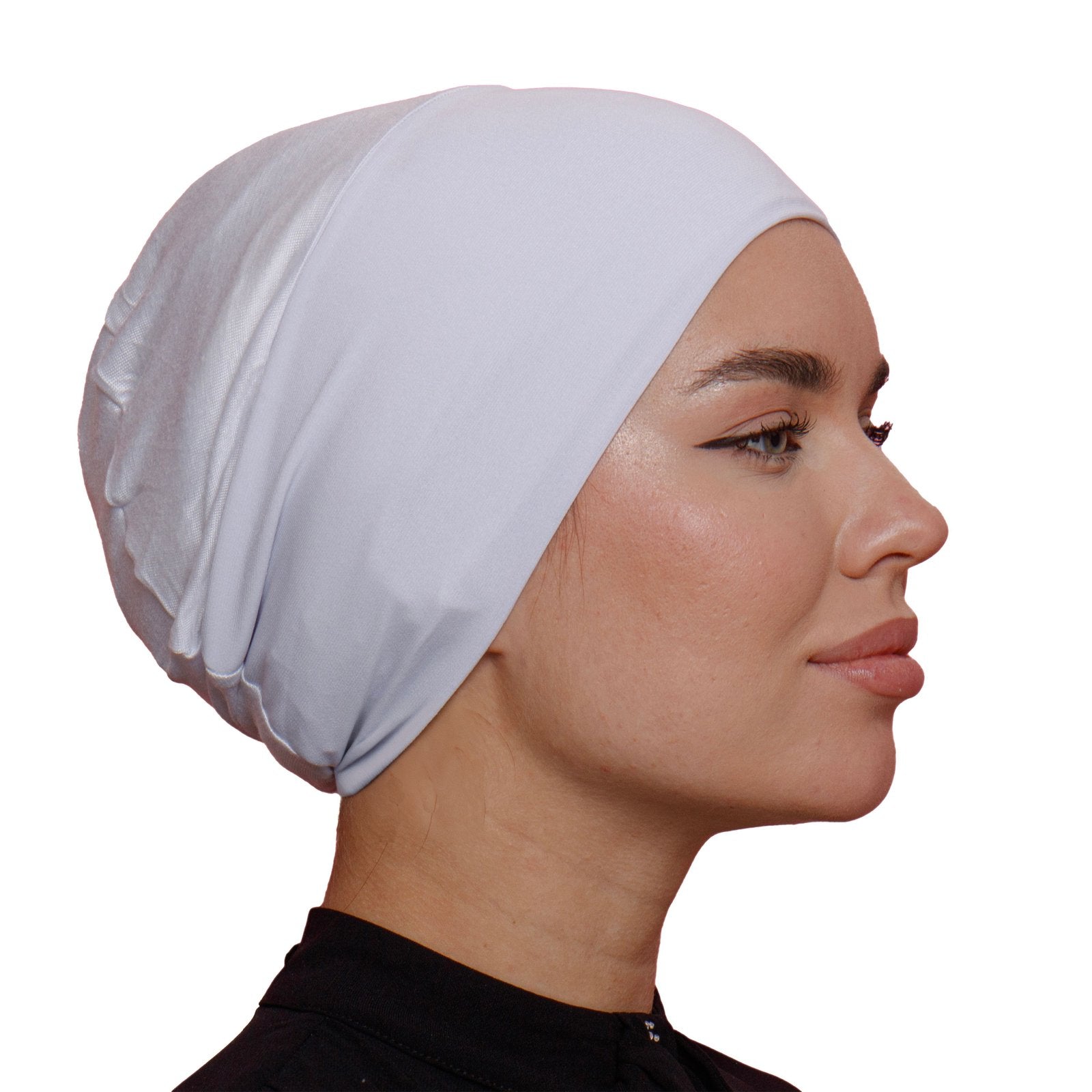 Side profile of a woman wearing a white lycra underscarf. Lightweight and soft, ideal for layering under any hijab style.