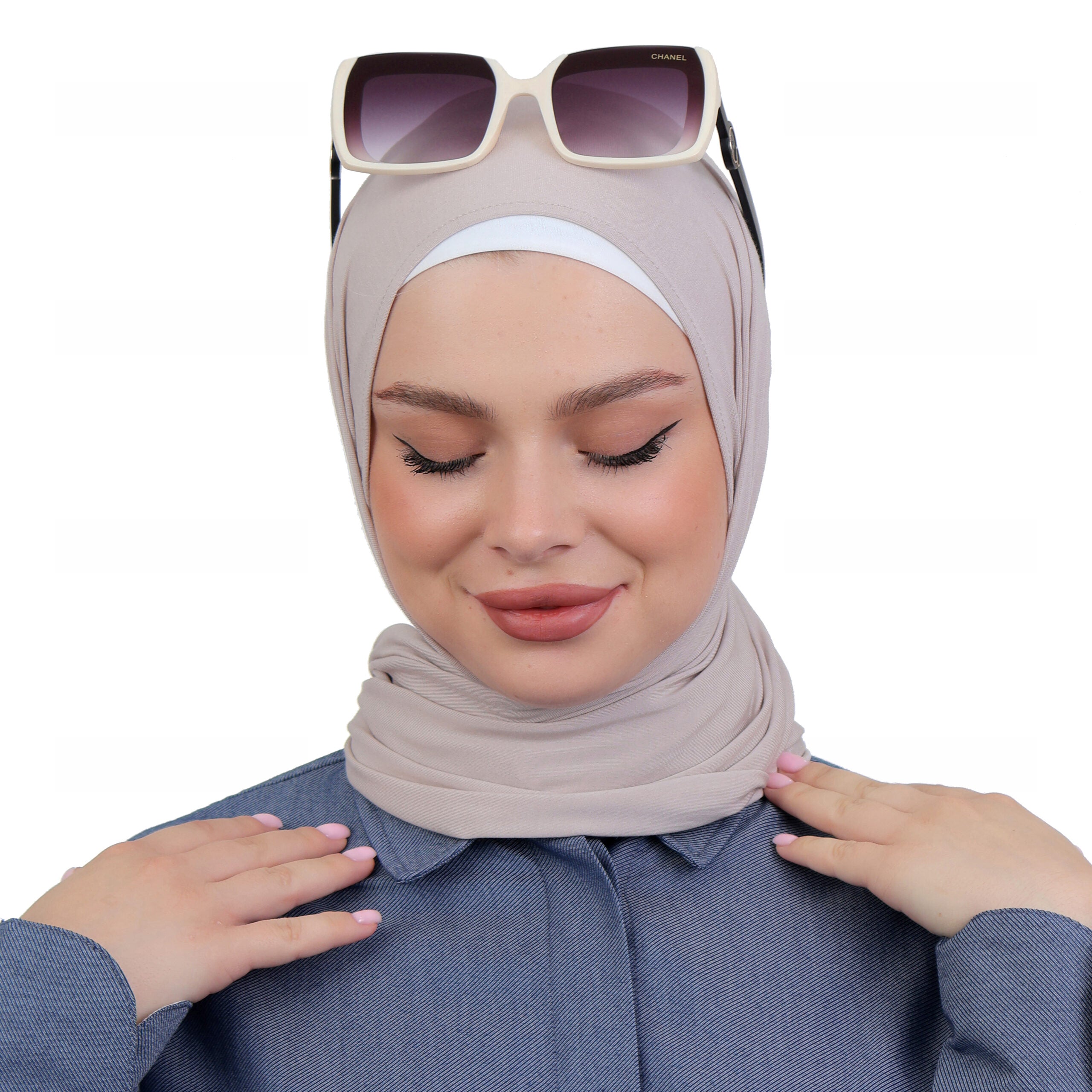 Model wearing a taupe triangle hijab styled with sunglasses for a modern and relaxed casual look.