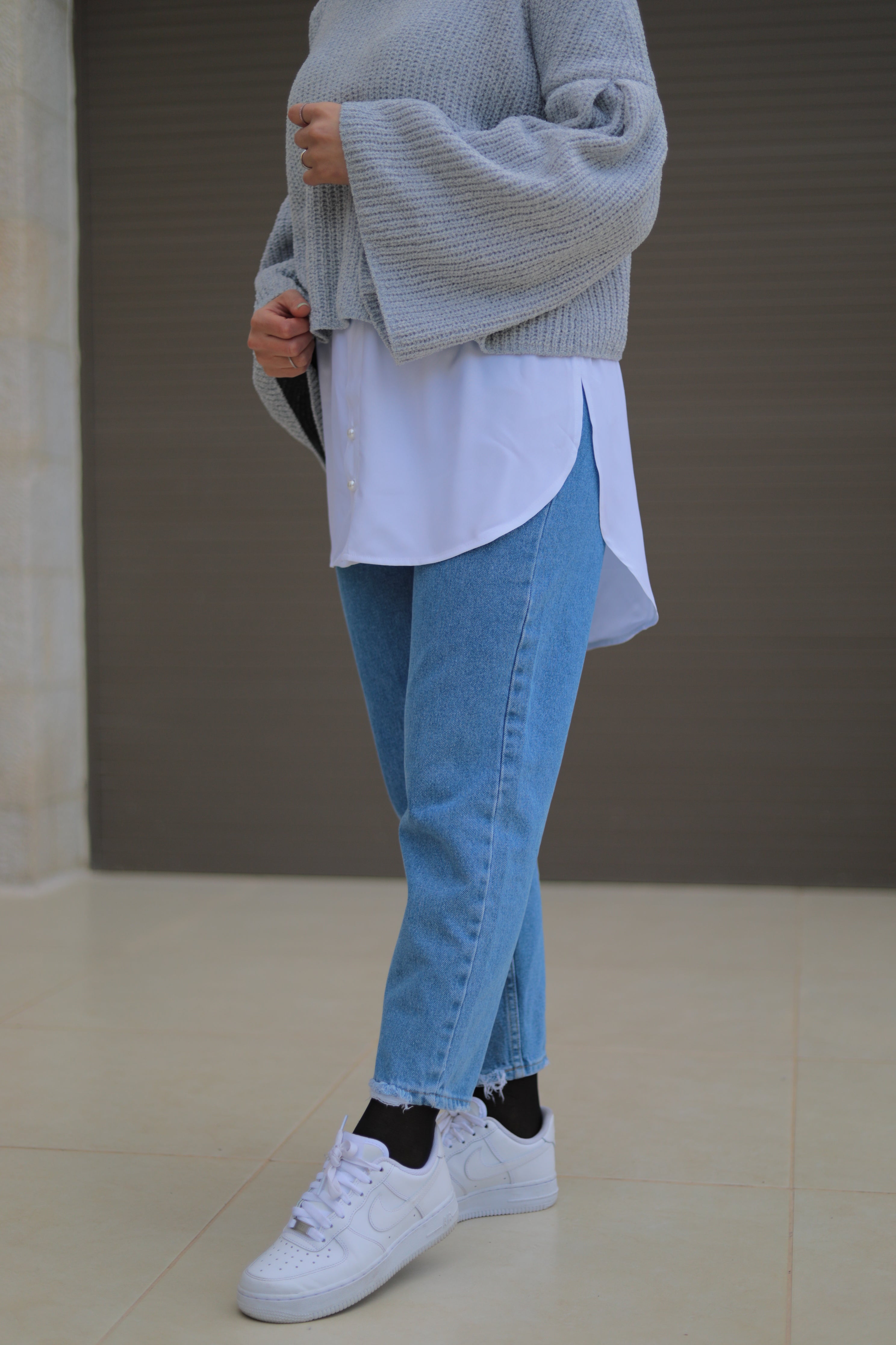 Casual streetwear featuring a long cardigan paired with light jeans, ideal for a relaxed yet modest look, extension skirt