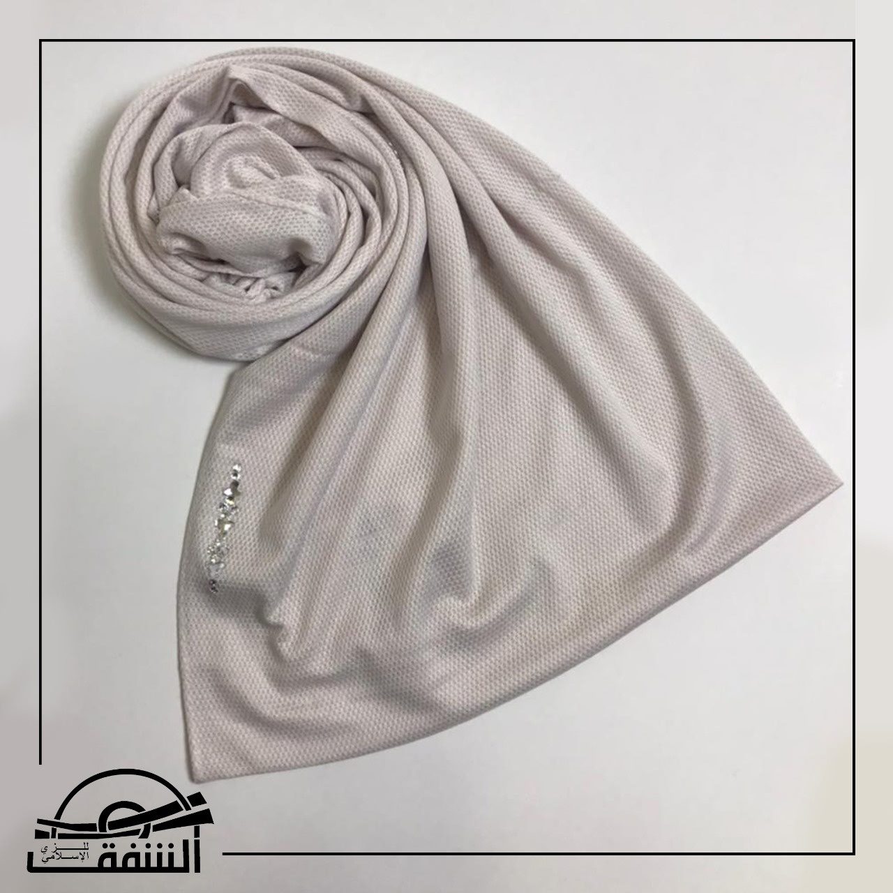 Silver shimmer-textured hijab displayed with intricate embroidery, perfect for special occasions and evening wear.
