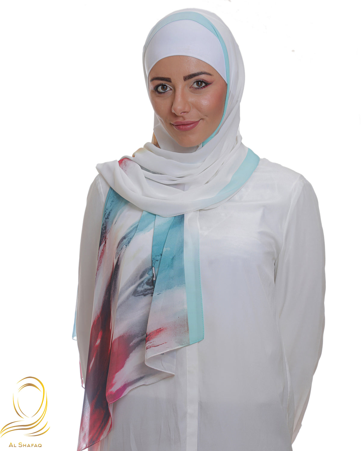 Model wearing a multi-colored abstract hijab in vibrant blues and reds, paired with a white blouse.