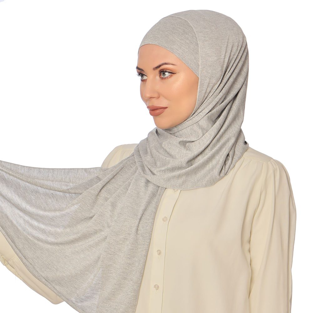 Model showcasing a lightweight, shimmer-textured silver hijab, paired with a cream blouse for an elegant look.