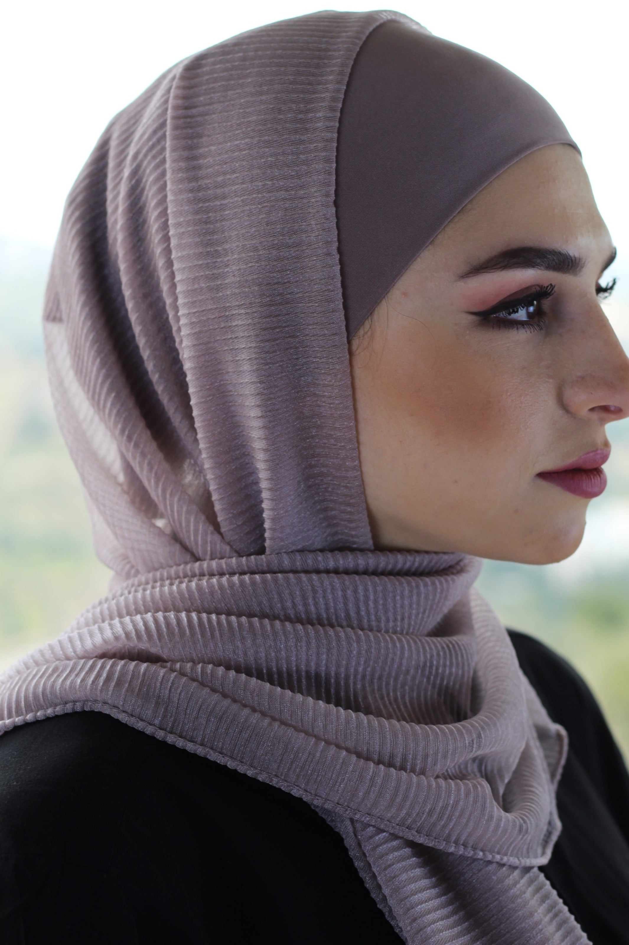 Close-up of a woman wearing a Lavender ribbed hijab. Soft, breathable fabric, ideal for daily hijab styling and comfort.