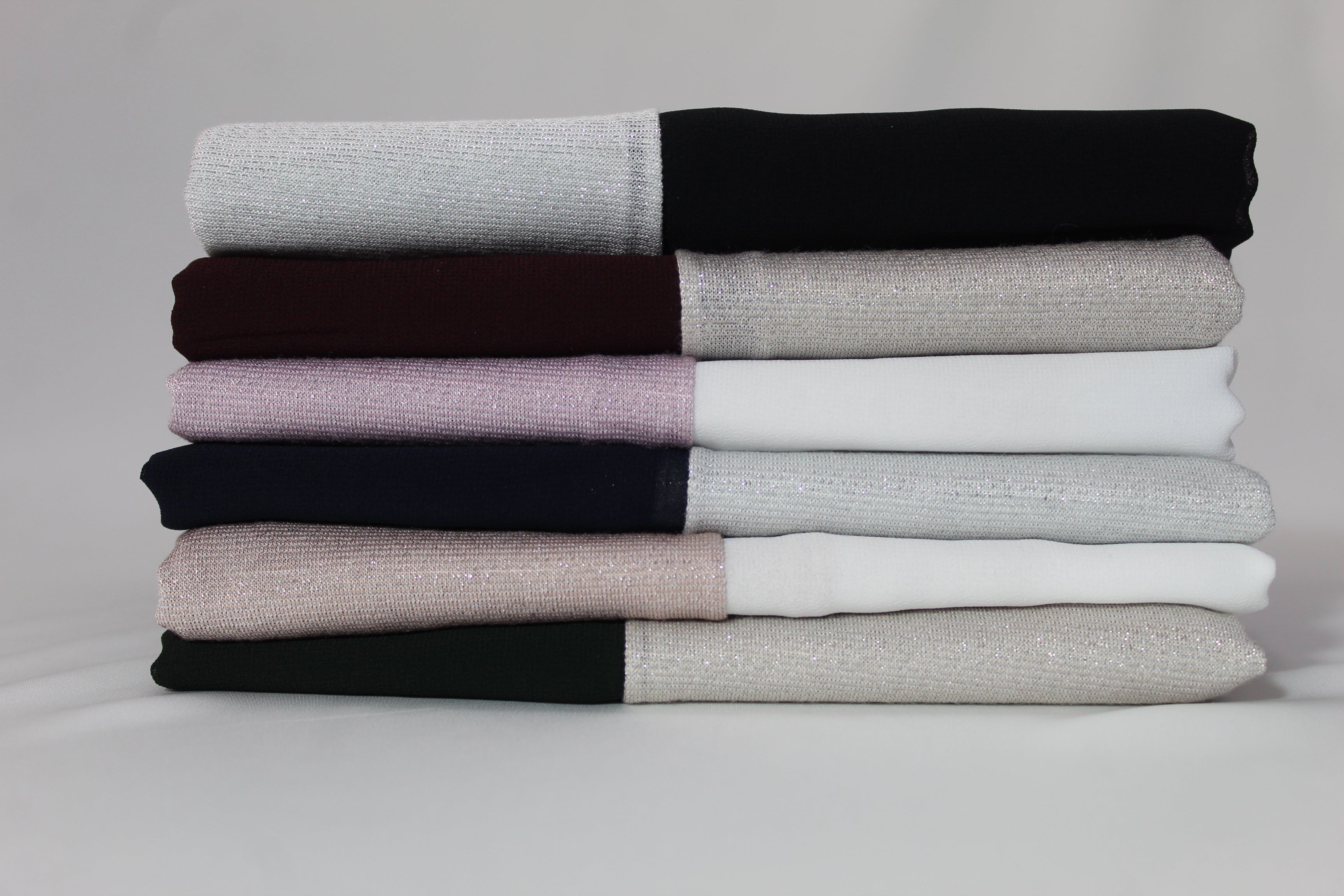 Stylish chiffon and lame hijabs with different colors stacked.