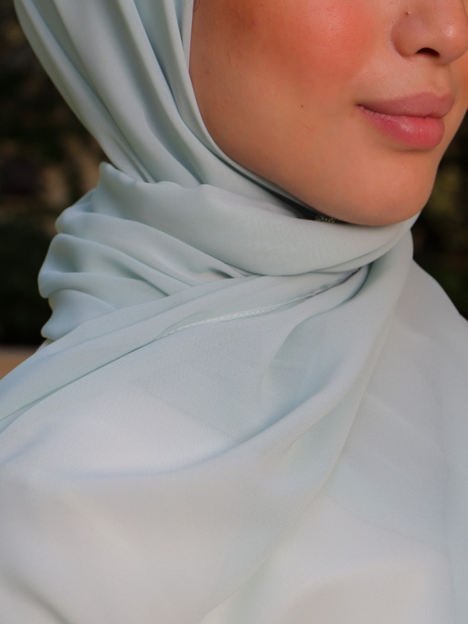 Close-up of a soft lavender hijab highlighting its smooth texture.