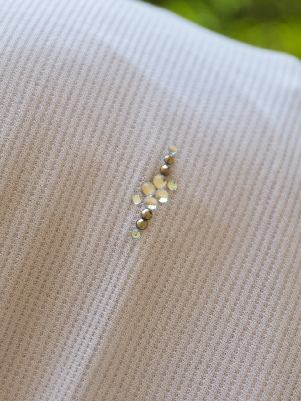 Close-up of a pearl-detailed hijab, featuring subtle vertical stripes for added texture.