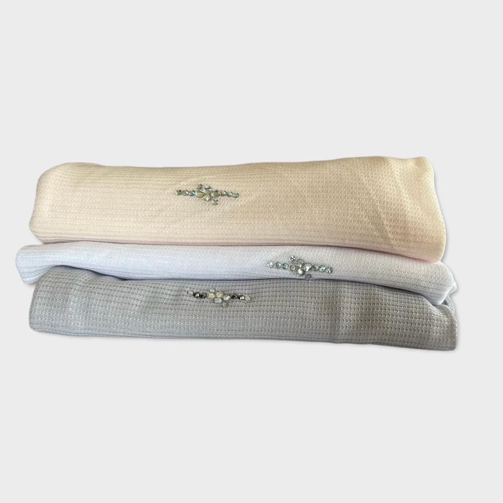 A set of premium embroidered hijabs in neutral shades, featuring delicate floral embellishments.